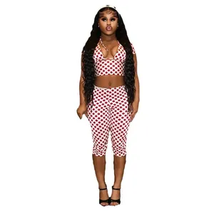 Full view of women's red polka dot print three-piece set including crop top and pants