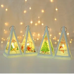 Set of 4 white Christmas pyramid lanterns with warm LED lights and festive prints