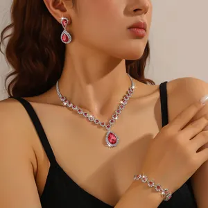 Detail view of elegant red rhinestone necklace earrings and bracelet jewelry set