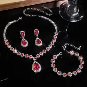 Detailed view of a luxury jewelry set featuring a red rhinestone necklace, earrings, and bracelet