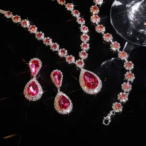 Elegant jewelry set featuring red water-drop rhinestones in a detailed close-up view.