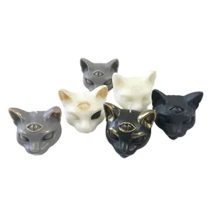 Set of gothic three-eyed cat scented candles for dark Halloween home decor in black and gold
