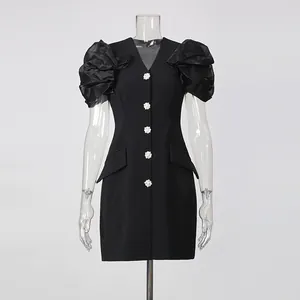 Elegant black V-neck blazer dress with pleated puff sleeves and rhinestone buttons.