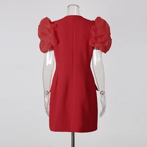 Back view of elegant red party dress with sheer puff sleeves.