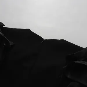 Macro view showing the hidden back zipper and neckline detail of a black banquet dress