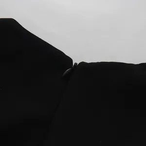 Detailed macro view of the hidden invisible back zipper on this elegant black suit dress