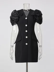 Elegant black V-neck blazer dress featuring pleated puff sleeves and crystal flower buttons