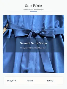 Close-up of navy blue satin robe fabric showing glossy sheen and soft fluid drape detail.
