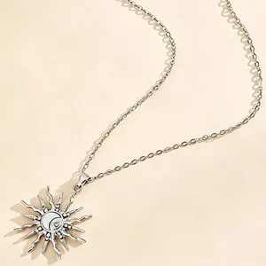 Detailed view of celestial sun and moon pendant necklace with inlaid rhinestones