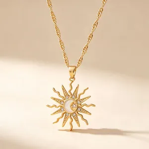 Close-up of gold alloy sun pendant necklace with moon and star details and rhinestones