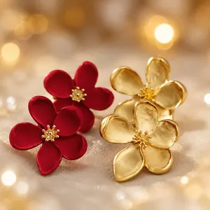 Macro view of vintage French romantic flower earrings in red and gold finish
