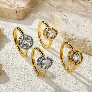 Collection of teardrop and round zircon hip-hop rings on a natural stone background