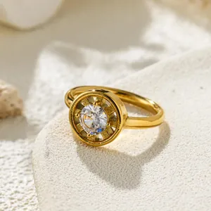 High-detail close-up of a gold-tone fashion ring with a sparkling round zircon stone