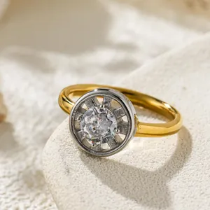Macro detail shot of a gold ring featuring a large sparkling circular cubic zirconia stone