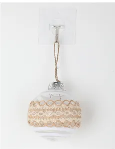 Close-up of a clear Christmas ornament ball with natural jute rope and glitter details.