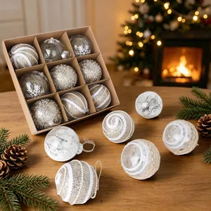 Set of elegant transparent Christmas ornaments with hemp rope details on wooden table