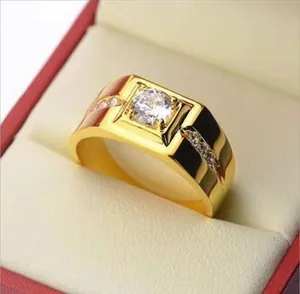 Close-up of gold-plated ring with a central square zircon and sparkling side stones.