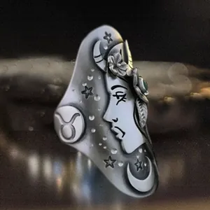 Close-up of vintage Taurus zodiac silver ring with a turquoise stone and moon detail