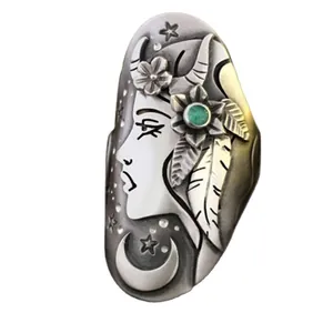 Detailed macro view of a vintage silver ring featuring a moon and goddess face design.