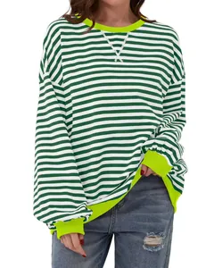Close-up of green and white striped long sleeve top with neon yellow ribbing