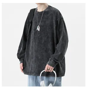 Close-up of the washed texture on a grey high-street long-sleeve tee with accessories