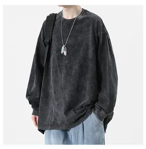 Detail of acid-washed oversized long-sleeved T-shirt with vintage streetwear vibe