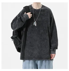 Close-up detail of oversized washed distressed long-sleeve T-shirt in retro charcoal grey cotton