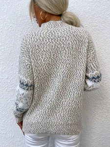 Back detail of a cozy women's mock neck sweater with white and blue snowflake patterns.