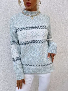 Close-up of women's blue and white snowflake knit sweater with semi-high collar
