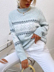Close-up of blue and white snowflake patterned turtleneck knit sweater for women
