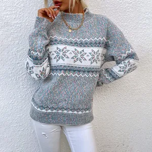 Elegant women's mock neck knit sweater with blue snowflake pattern for Christmas holiday.
