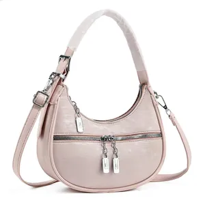 Chic pink crescent underarm bag with textured fabric and silver-tone hardware accents
