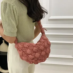 Detail of pink pleated bubble cloud bag with soft quilted texture for casual wear