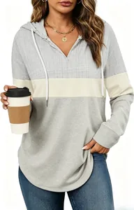 Detail shot of the front of a women's color-block plaid hoodie with a drawstring V-neck