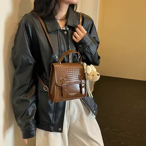 Brown woven texture preppy style satchel with cute bear pendant and leather jacket styling