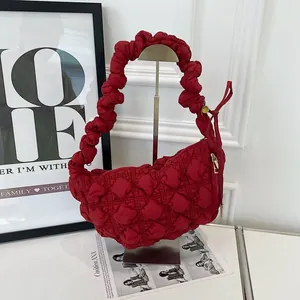 Detail view of the red bubble quilted cloud bag with ruffled shoulder strap