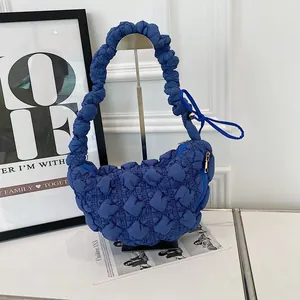 Close-up of blue bubble textured dumpling bag with unique popcorn fabric design style