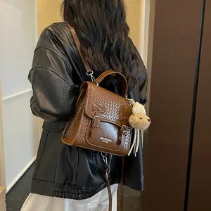 Brown woven leather backpack worn by model, showing stylish retro design detail.