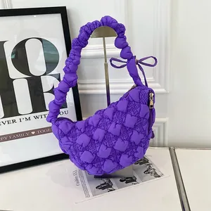 Vibrant purple puffy bubble cloud bag with ruffled shoulder strap and chic bow detail