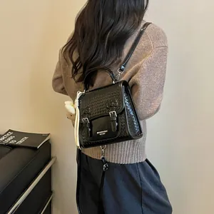 Fashionable black college style woven backpack for women worn by a model in a casual setting