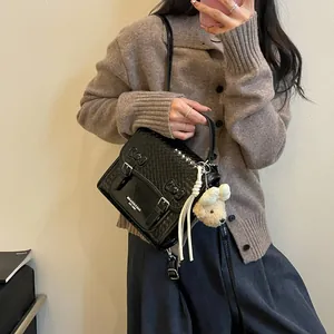 Fashionable black women's backpack with cute bow details and a plush bear charm
