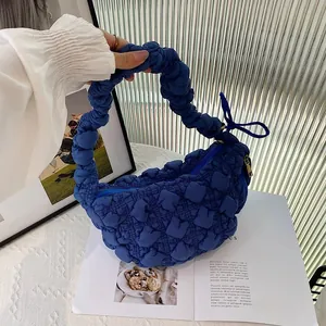 Detail shot of a royal blue bubble pleated cloud bag featuring unique puffy texture