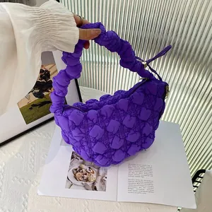 Detailed view of a purple quilted bubble bag with pleated texture and cloud shape