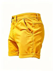 Detailed side view of men's slim fit yellow casual denim shorts with rolled hems