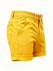Side view detail of bright yellow slim fit denim shorts featuring rolled hems and stitching.