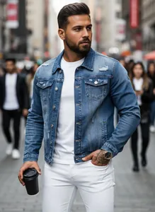 Close-up of distressed blue denim jacket worn by man in urban street setting