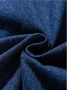 Close-up macro view of dark blue denim fabric texture showing twill weave pattern