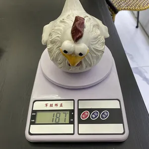 Funny big eye chicken resin ornament weighing 187g on a digital scale for garden decor.