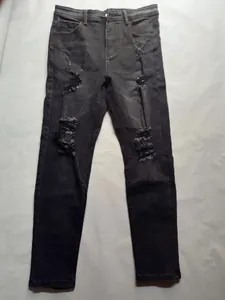 Frontal view showing distressed ripped details on men's slim fit charcoal grey denim jeans