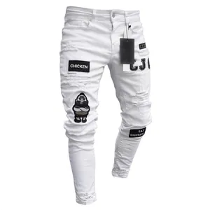 Detail view of men's white distressed skinny jeans with stylish hip hop embroidered patches